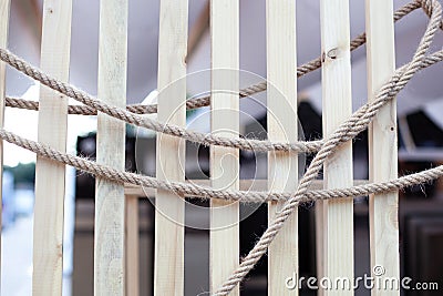 Abstract background close up Arranging rope on wood texture boards. brown nautical knotted rope on wooden planks. Jute rope. sisal Stock Photo