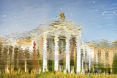 Abstract background. Close up view of blurred reflection of bright building in water Stock Photo