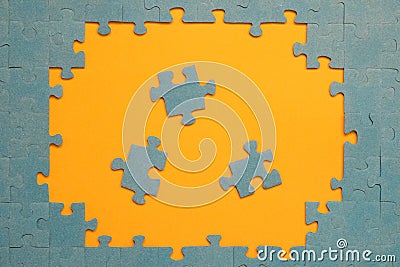 Abstract background of many puzzles on an orange background. The concept of teamwork Stock Photo