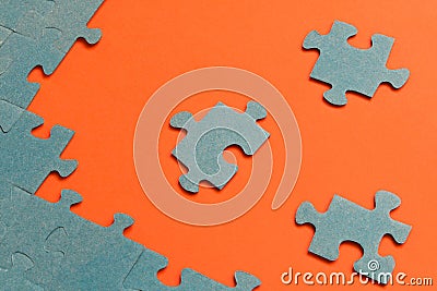 Abstract background of many puzzles on an orange background. The concept of teamwork Stock Photo