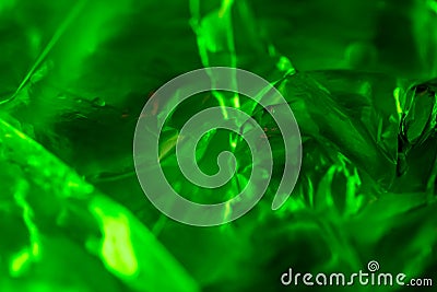 abstract background. neon green. macro photo of crumpled plastic bag with green light. Stock Photo