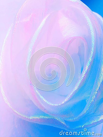 Abstract background, neon holographic fabric folded in the shape of a rose. Stock Photo