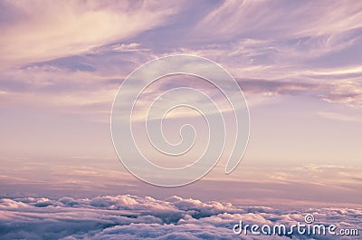 Abstract background with pink, purple and blue colors clouds. Sunset sky above the clouds. Stock Photo