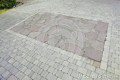 The inner yard is paved with decorative stone. Stone pavement, paved rectangular red blocks. A stone pavement. Stock Photo