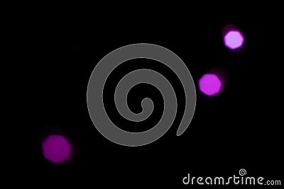abstract background some shiny defocused purple particles on black background Stock Photo