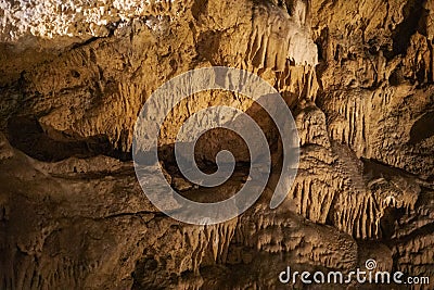 Abstract background of stalactites, stalagmites and stalagnates in a cave, horizontal Stock Photo