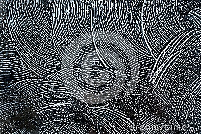 Abstract background. Swirling soap sud foam pattern on window with dark background. Stock Photo