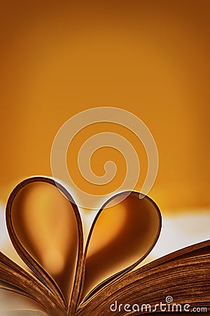 Abstract background with a tan accent. Old book. An open book with a heart folded from folded sheets. Love education concept Stock Photo