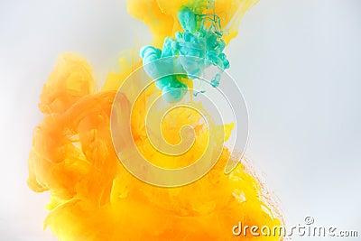 abstract background with turquoise and orange paint swirls in water, isolated on grey Stock Photo