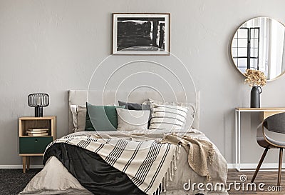 Abstract black oil painting in frame on empty beige wall of cozy bedroom Stock Photo