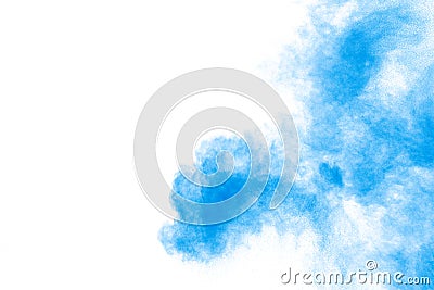 Abstract blue dust explosion on white background. Freeze motion of blue powder splash. Painted Holi in festival Stock Photo