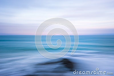 Abstract blue ocean sunset shoreline ICM blur streaked seascape Stock Photo