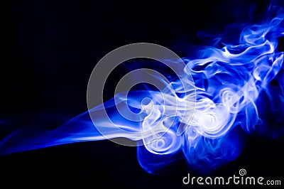 Abstract blue smoke swirls over black background Stock Photo