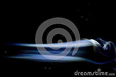 Abstract blue smoke swirls over black background Stock Photo