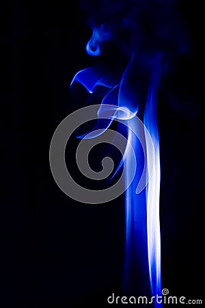 Abstract blue smoke swirls over black background Stock Photo