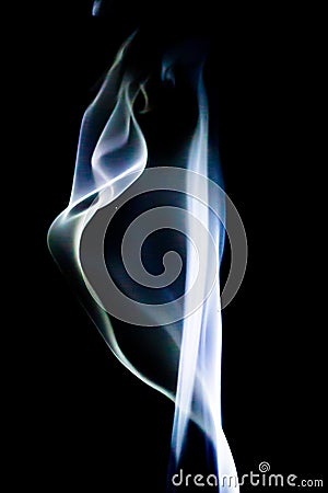 Abstract blue smoke swirls over black background Stock Photo