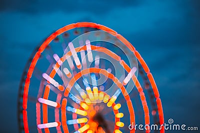 Abstract Blur Of Brightly Colorful Illuminated Ferris Wheel In Amusement City Park. Bokeh Boke Background Stock Photo