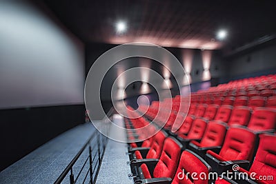 Abstract blur Empty rows of red theater or movie seats. Chairs in cinema hall. Comfortable armchair Stock Photo