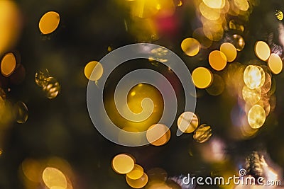 Abstract blurred christmas background with christmas tree decorated with shiny goden balls and illumination lights Stock Photo