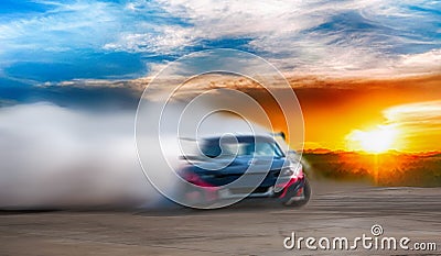 Abstract blurred drift car with smoke from burned tire at sunset Stock Photo