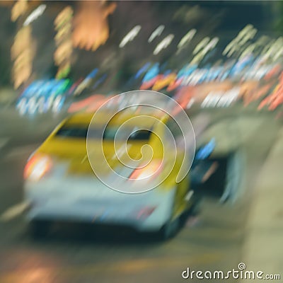 Abstract blurred evening traffic. Close-up of stopped yellow taxi. Urban modern background Stock Photo