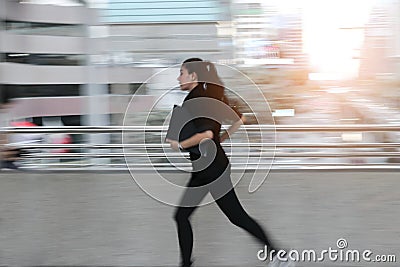 Abstract blurred motion of young Asian business woma running to work Stock Photo