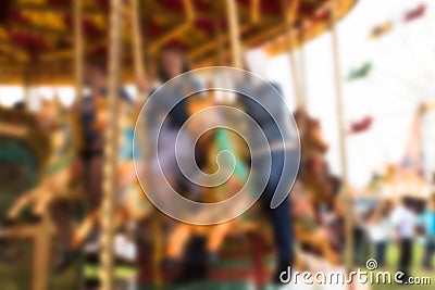 Abstract blurred people riding on carousel horse Stock Photo