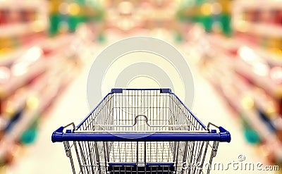 Abstract blurred photo of supermarket with empty shopping cart Stock Photo