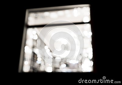 Abstract blurred windows with light bokeh at night. Defocused bokeh lights background. Concept of nightlife at home through the wi Stock Photo