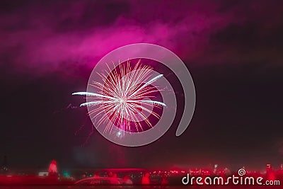 Abstract bright blurred background of fireworks, silhouettes of unrecognizable people back to us, celebrate holiday Stock Photo