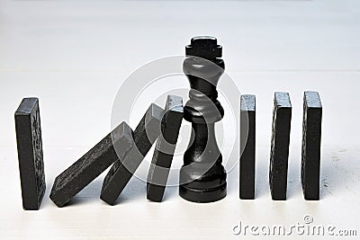 Abstract business concept with King chess piece and domino pieces fallen Stock Photo