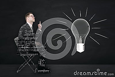 Abstract businessman outline filled with mathematical formulas sitting and pointing up on chalkboard wall backround with light Stock Photo