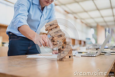 Abstract businessmen fail danger tower block game building construction protect plan and project control Stock Photo