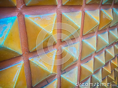 Abstract ceramic wall tiles in the shape of pyramid background. Stock Photo