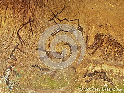 Abstract children art in sandstone cave. Black carbon paint of human hunting on sandstone wall Stock Photo