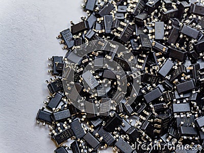 Abstract close-up of scattered surface mount chip computer semiconductor components Stock Photo