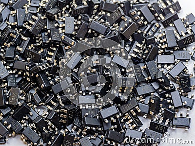 Abstract close-up of scattered surface mount chip computer semiconductor components Stock Photo