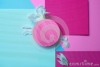Abstract close up top view round wooden mock up,geometric pattern paper shapes.Triangle,rectangle in pink blue colors Stock Photo