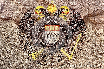 Faded Coat of arms of Cologne isolated on weathered solid rock wall background Stock Photo