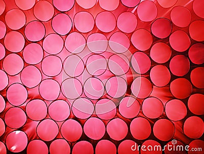 Abstract pink colorful background of stack pipes Stock Photo