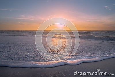 Abstract dreamlike seascape in soft blue and yellow colors. Ocean, sandy beach, and cloudy sky Stock Photo