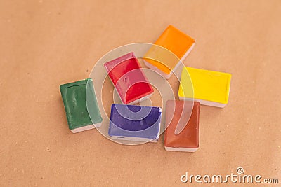 Fugural still life photo image of bright waterpaint bloks on craft paper Stock Photo