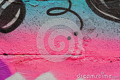 Abstract fragment of wall with detal of graffiti, old chipped paint, scratch, grunge texture. Aerosol design, pink-blue Stock Photo