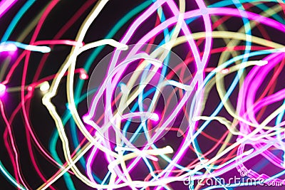 Abstract freezelight background from multicolored spiral stripes on a black . Stock Photo