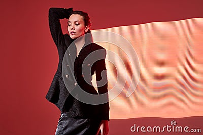 abstract futuristic photo, confident female model on neon pattern in wave shape in the background Stock Photo