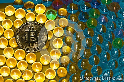 abstract futuristic vibrant background with 3d balls in various colors in the yellow part of bitcoin coins, new age cryptoworld Editorial Stock Photo