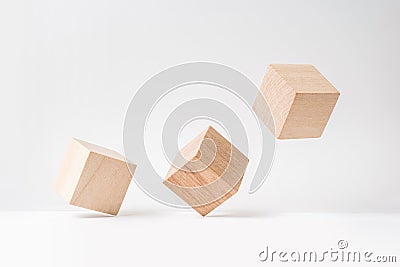 Abstract geometric real wooden cube with surreal layout on white floor background, the symbol of leadership, teamwork and growth Stock Photo