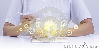 Abstract glowing light bulb over laptop of businessman with digital marketing media and icon network innovation future Stock Photo