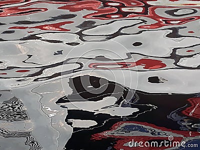 abstract image formed by reflection of a boat on river water Stock Photo