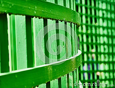 Abstract image of a green curved fence on which raindrops hang Stock Photo